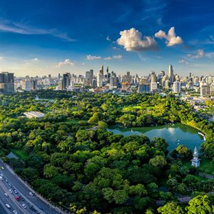 Sunset scence of modern office buildings and condominium in Bangkok city downtown with sunset sky and clouds at Bangkok , Thailand. Lumpini park