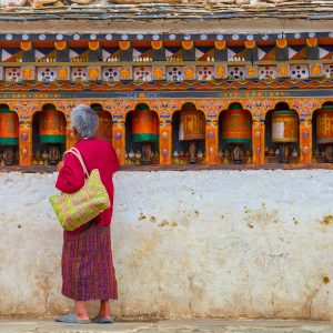 a Bhutanese woman & prayer wheels, Thimpu, Bhutan